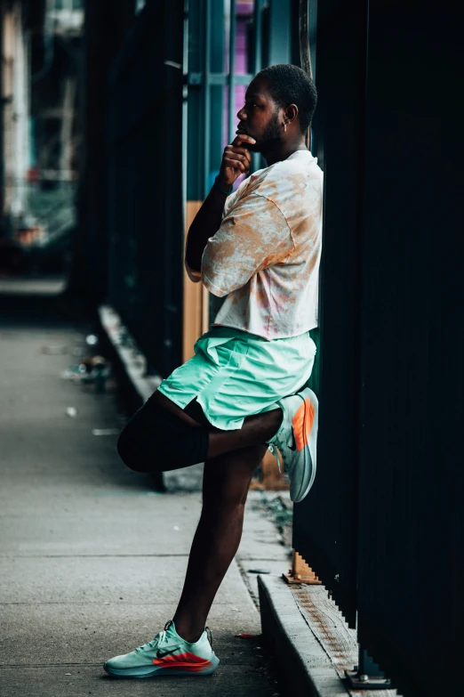 a man standing on a sidewalk talking on a cell phone