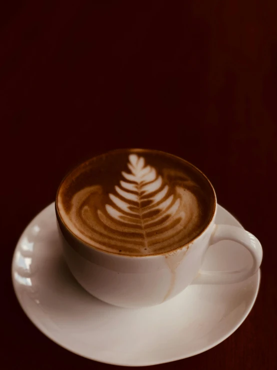 a cappuccino with a leaf shape on top