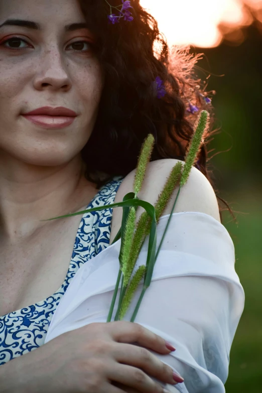 a woman holding flowers in the back of her arm