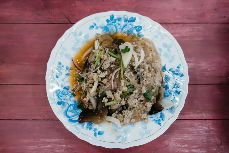 a plate full of rice, meat and vegetables