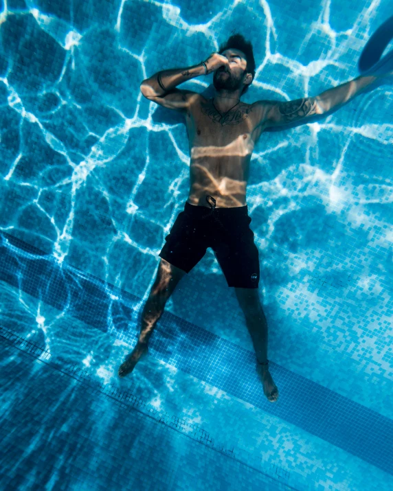 a man that is in the water with a frisbee