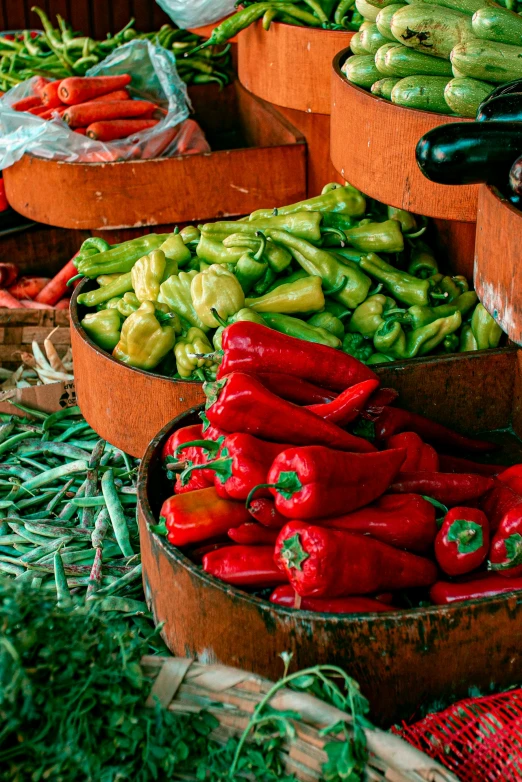 several wooden buckets filled with vegetables sitting on display