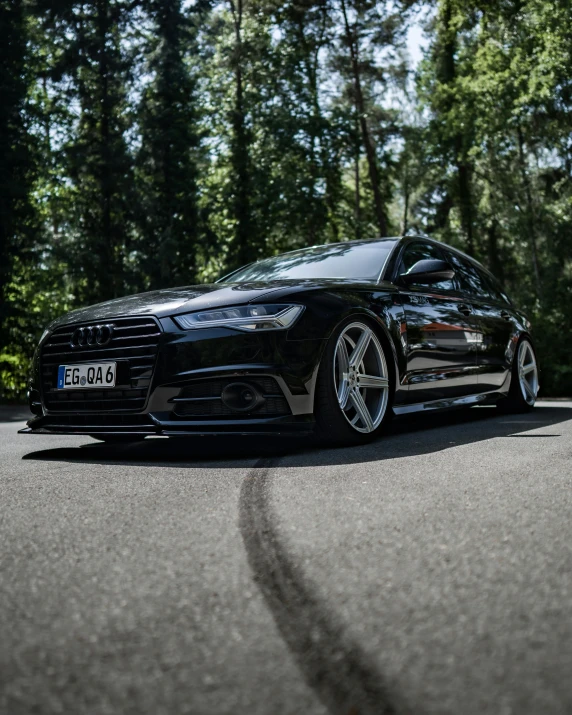 black car on a corner near many trees