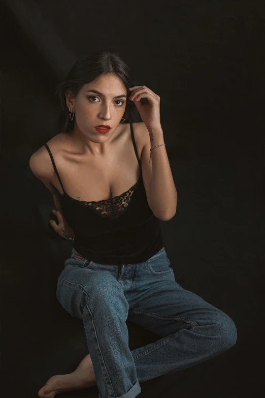 a woman in black top sitting on the ground