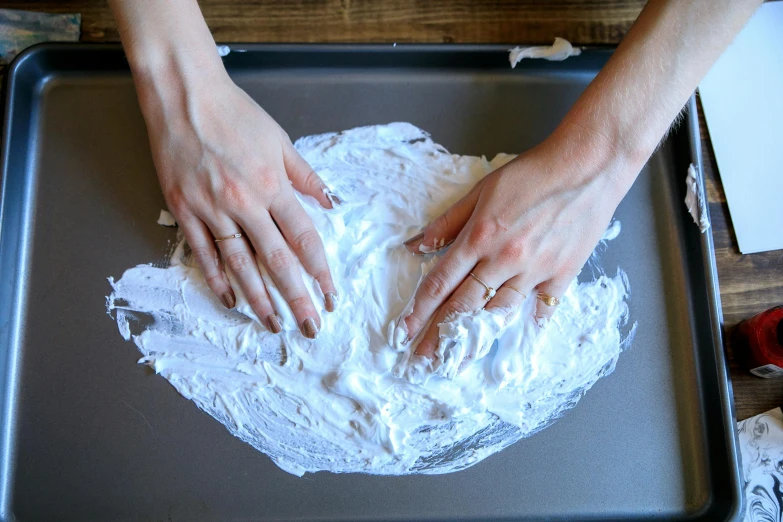 someone has their hands on top of a dough