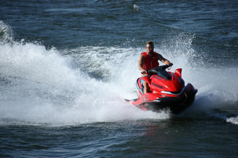 a man riding a jet ski on top of water