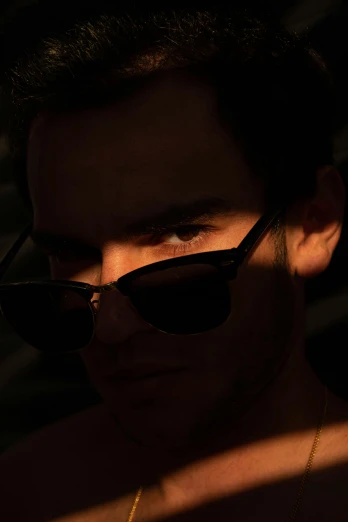 the man's face is partially obscured by sunglasses