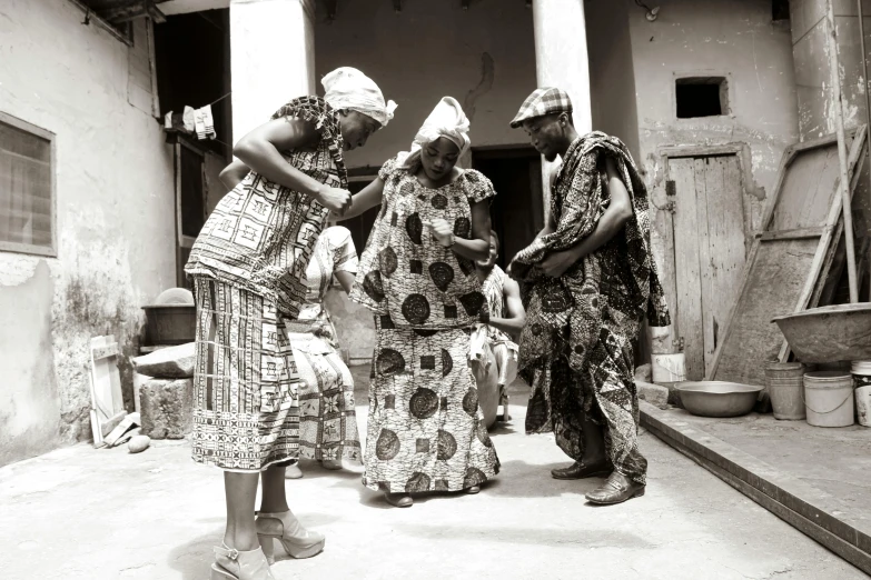 three women stand in an alley way with their hands on the ground