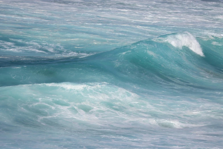 a body of water with many wave cresting up