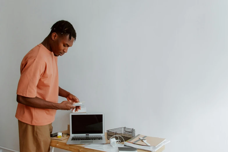 a man is checking the contents of a small open laptop