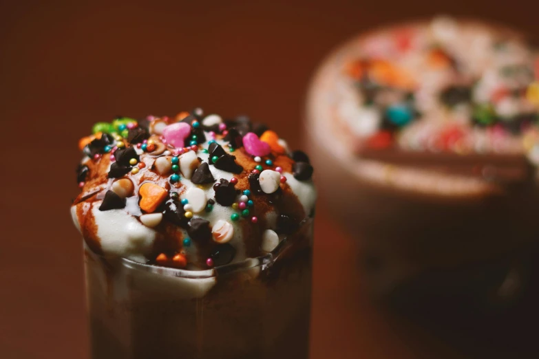 an iced drink has chocolate sprinkles and colorful candy