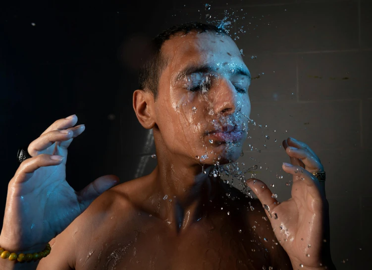 a person that is spraying a face with some water