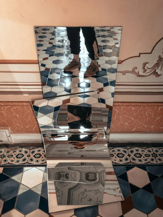 the man is reflected in this mirrored object