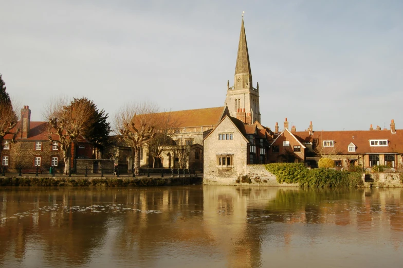 a pond that has a church in the background