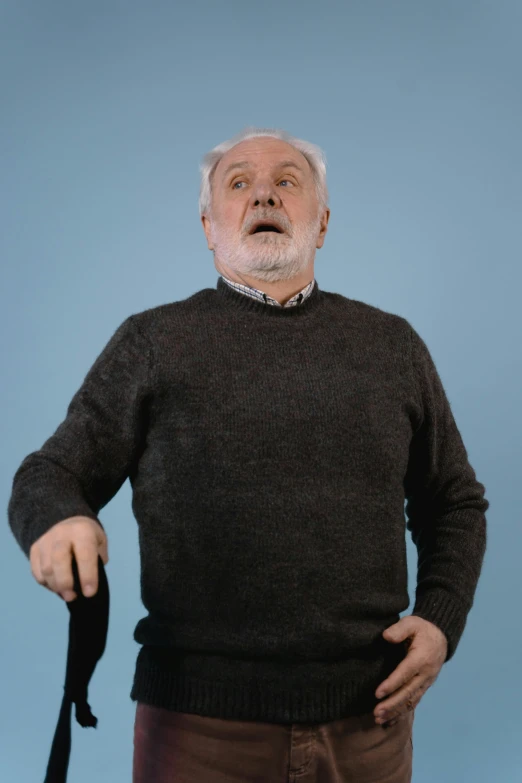 man in a sweater has an umbrella over his shoulder