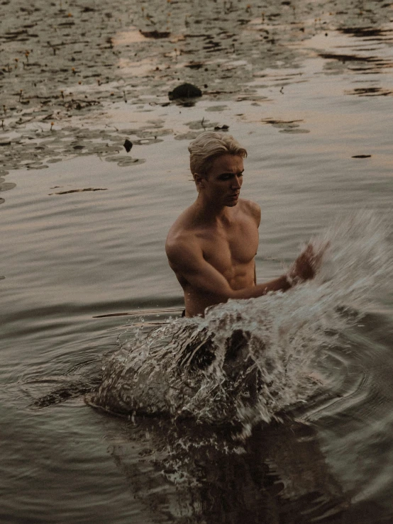 a man swims in the water with an object on his feet