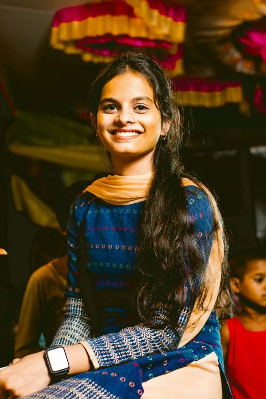 a woman standing with a child next to her and another  in the background