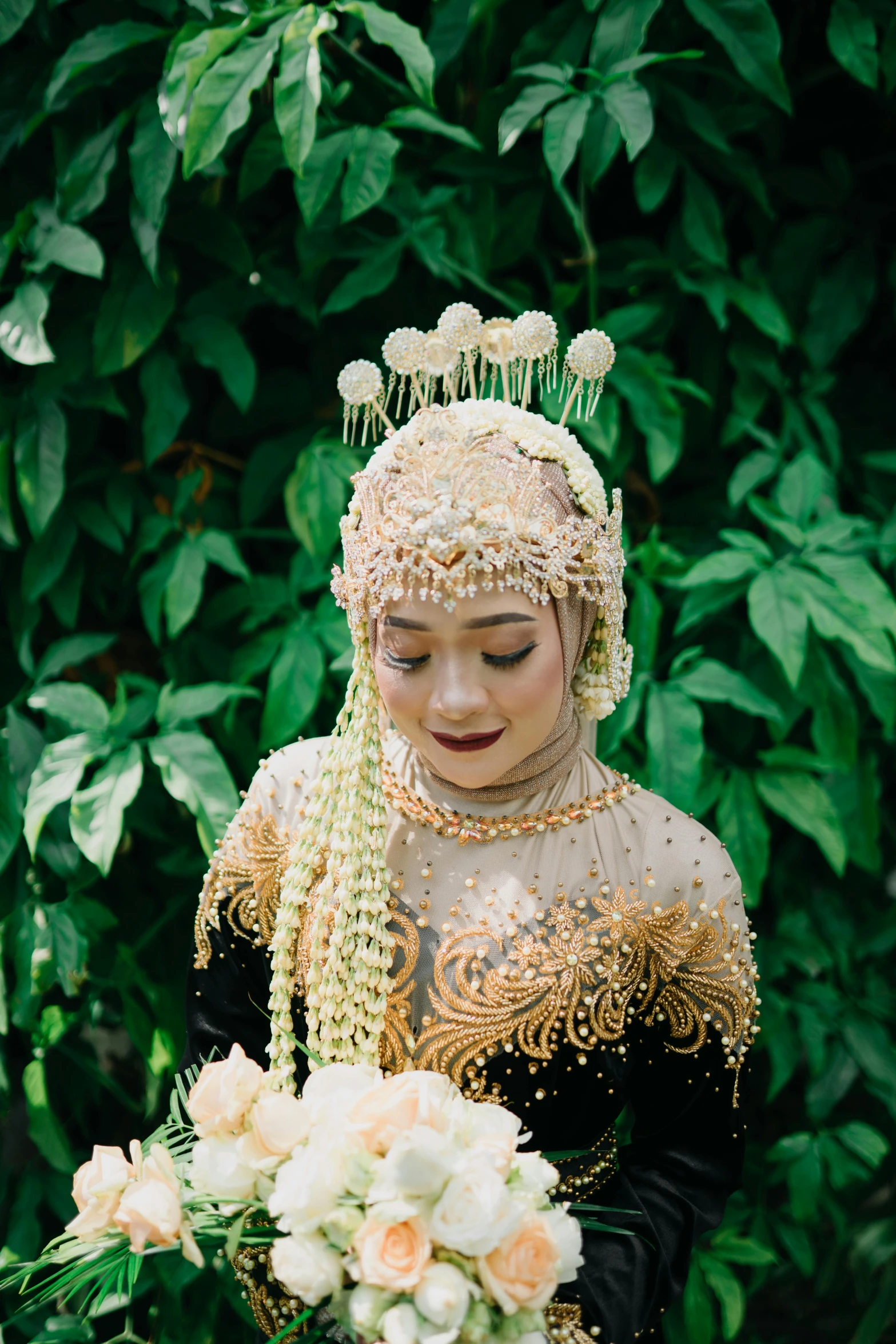 bride in a green and gold wedding dress holding a bouquet