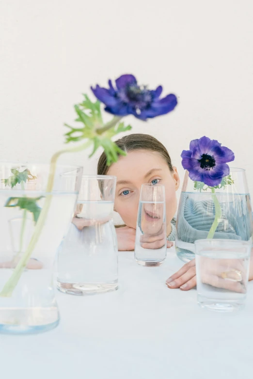 a person in a table with four water glasses