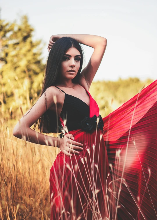 a beautiful woman posing for a portrait in tall grass