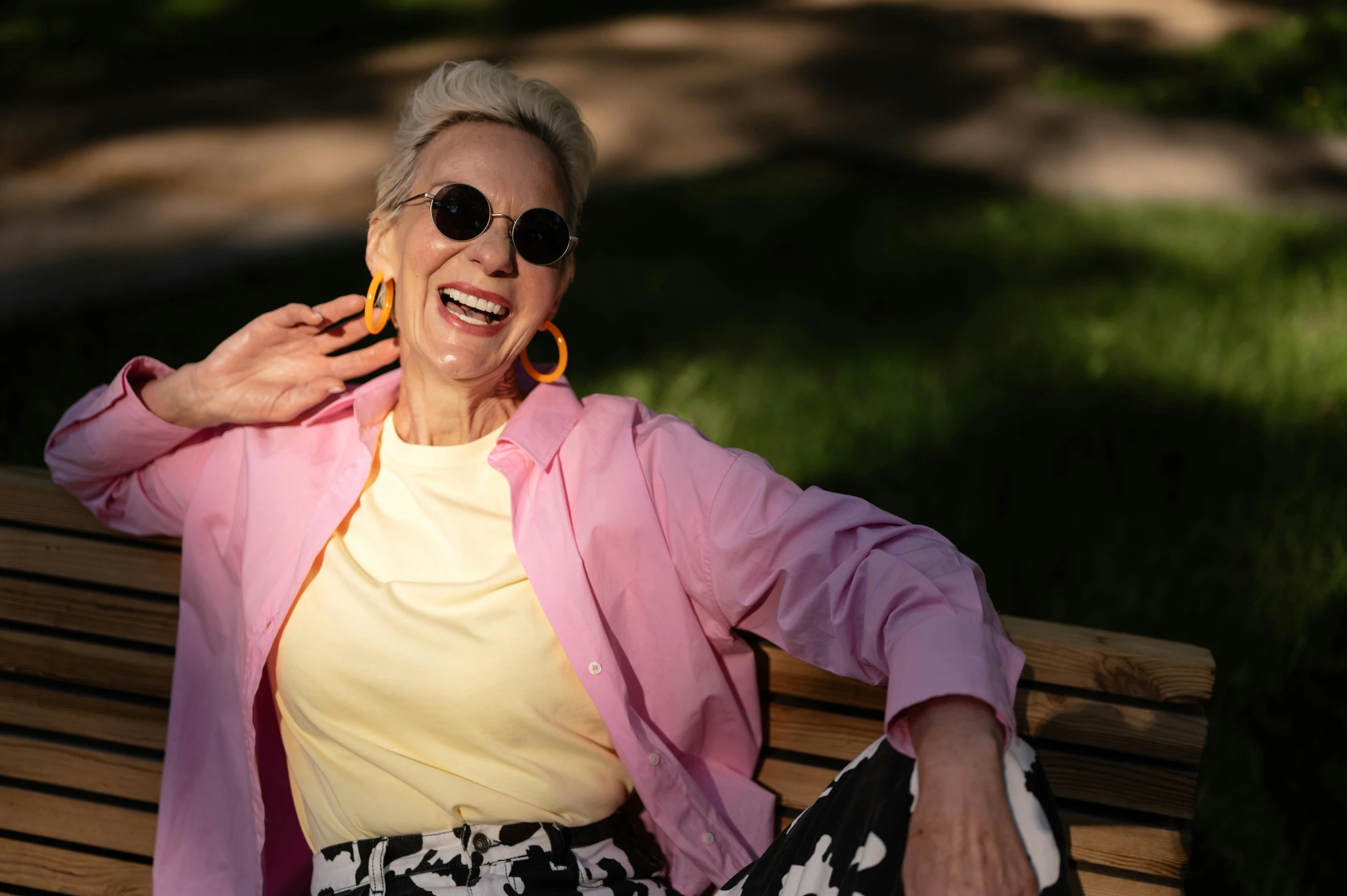 an older lady is smiling while holding onto some earrings