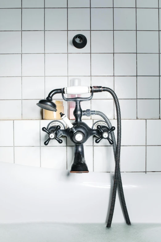 a bath tub and toilet connected with a black faucet