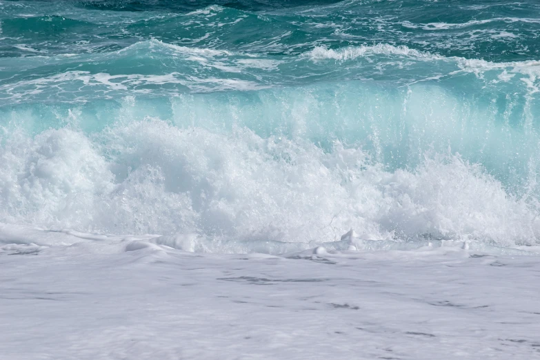 an ocean with waves coming and green water