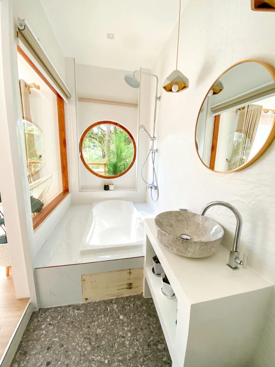 a white bathroom with a sink and bath tub