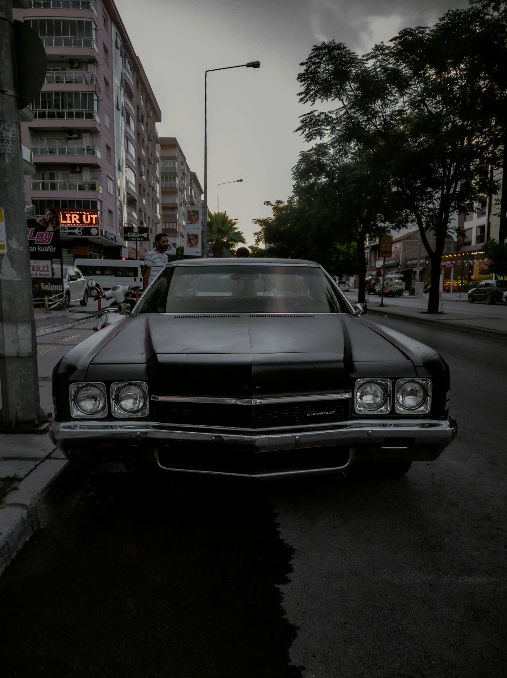 a car is parked on the side of the street