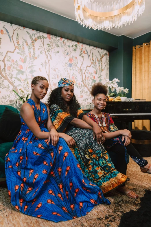 three ladies are dressed up in colorful attire