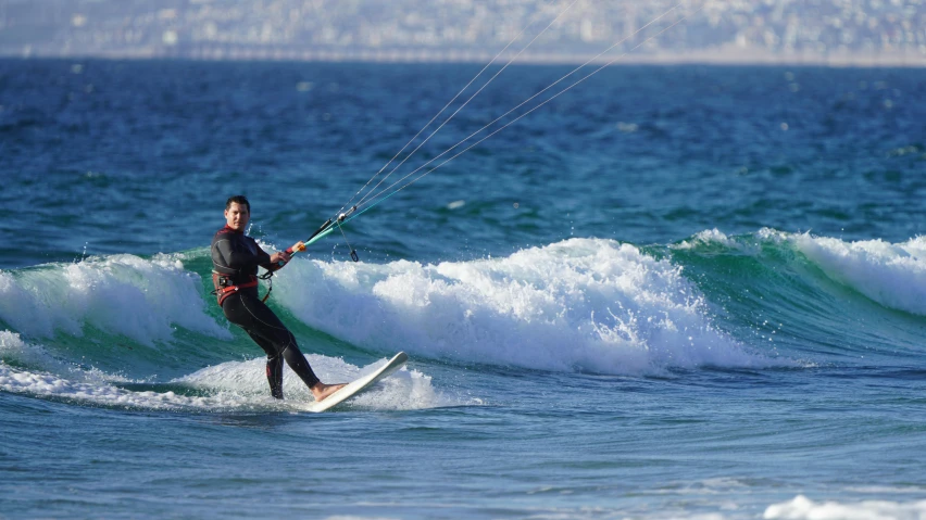 a man riding a surf board on top of a wave