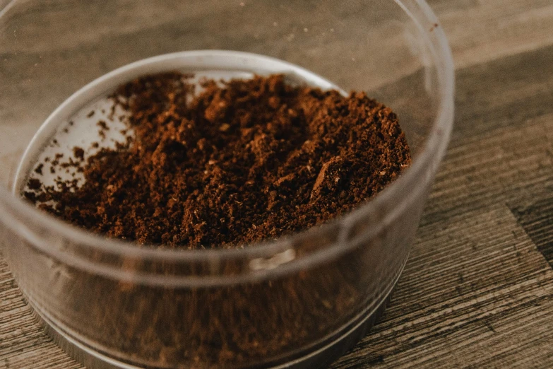 small clear cup filled with brown powder