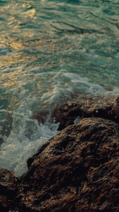 an object that is sitting on the rocks next to the water