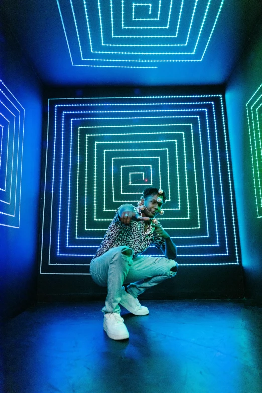 a man in the middle of a room with neon lights