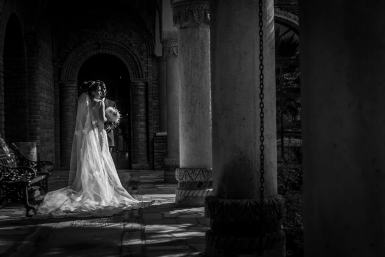 a bride and groom emce in a dimly lit room