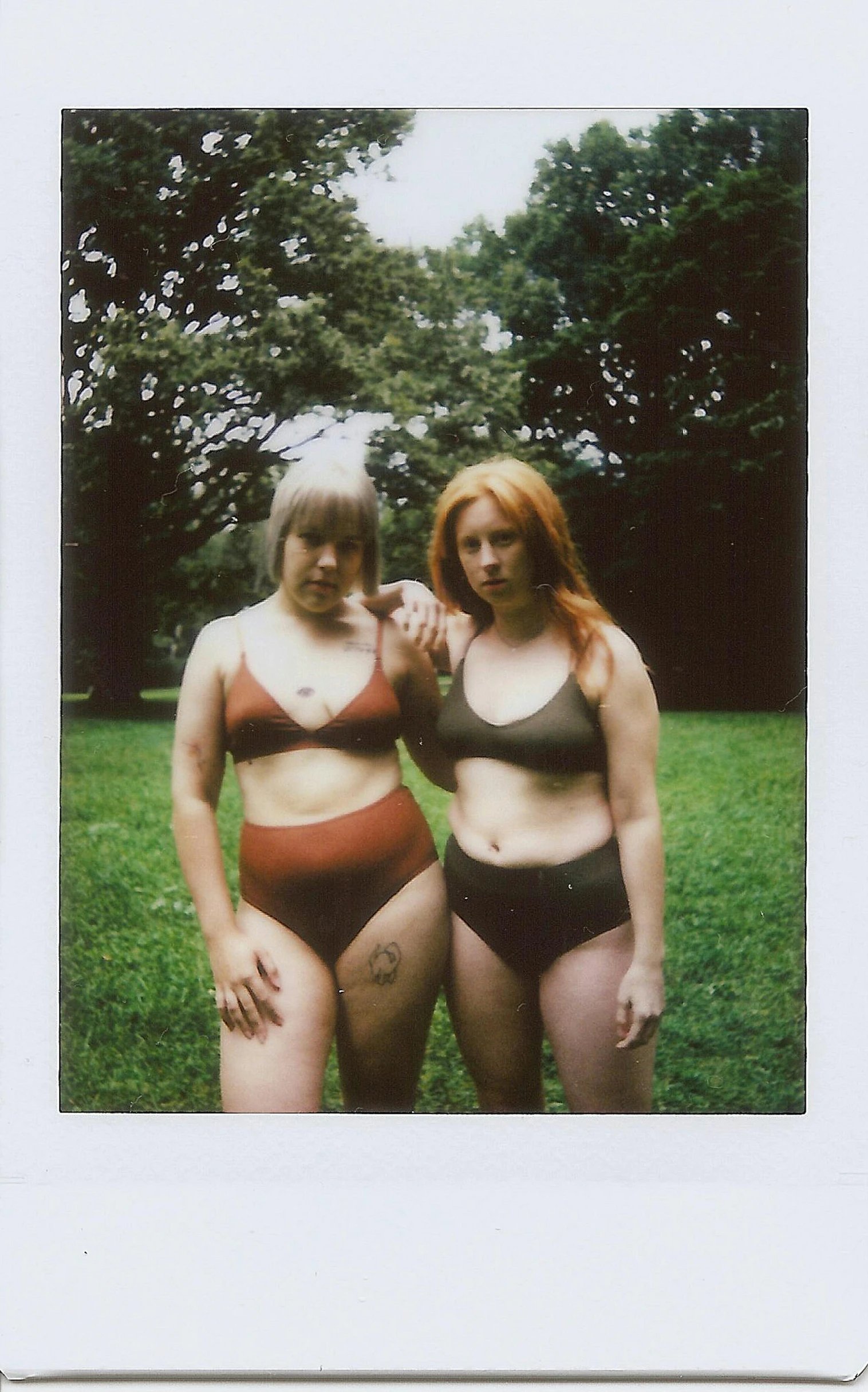 two women with brown s standing in the grass