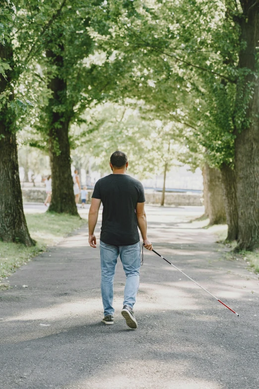 a man walking a dog down a street
