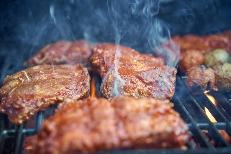 meat cooking on a grill in the dark