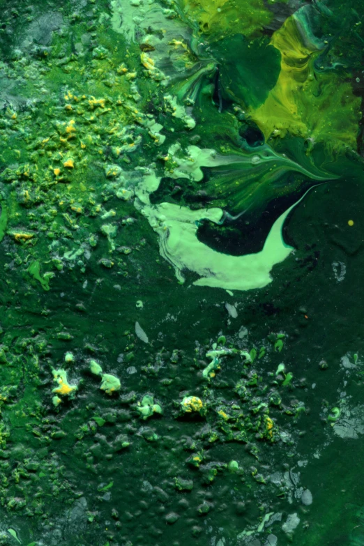 green and white paint flowing down a wall