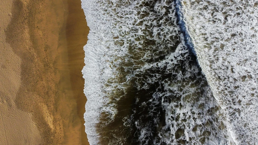 a view of the water from above looking down on the beach