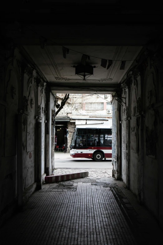 a bus is parked in an open doorway