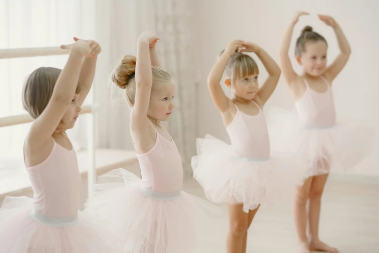a group of s in pink ballet outfits