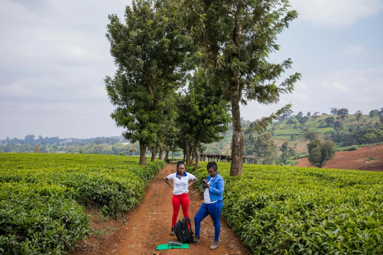 two men are standing next to each other in a field