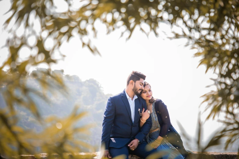 a couple of people in formal clothing on a rock