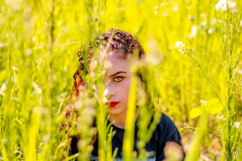 a  looking at the camera in tall grass