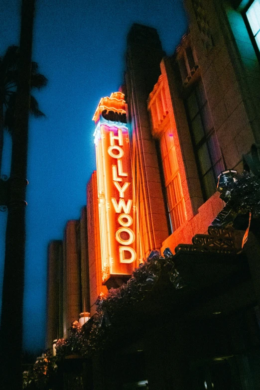 a neon sign for the hollywood movie theater