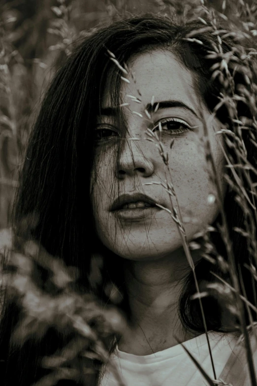 the girl is standing in the tall grass