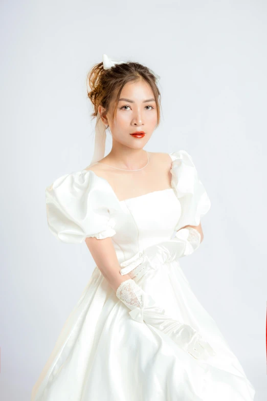 an asian woman in white gown, with large sleeves