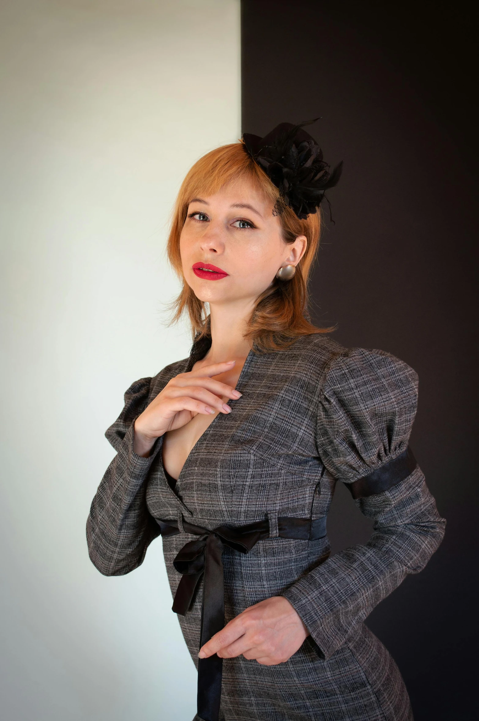 a women with a suit and red lipstick