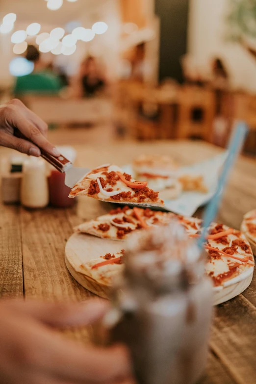 a man eating pizza at a table in a restaurant